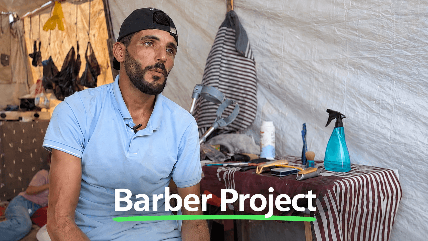 A Palestinian barber setting up his tent barbershop